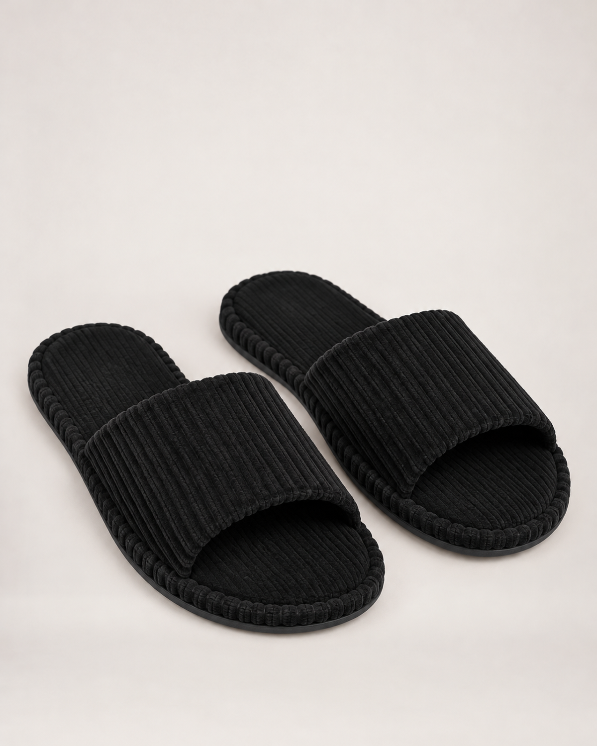 Men's black corduroy open-toe slippers, front three-quarter studio view