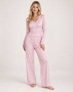 Women's pink V-neck button-front pyjama set, front three-quarter studio view
