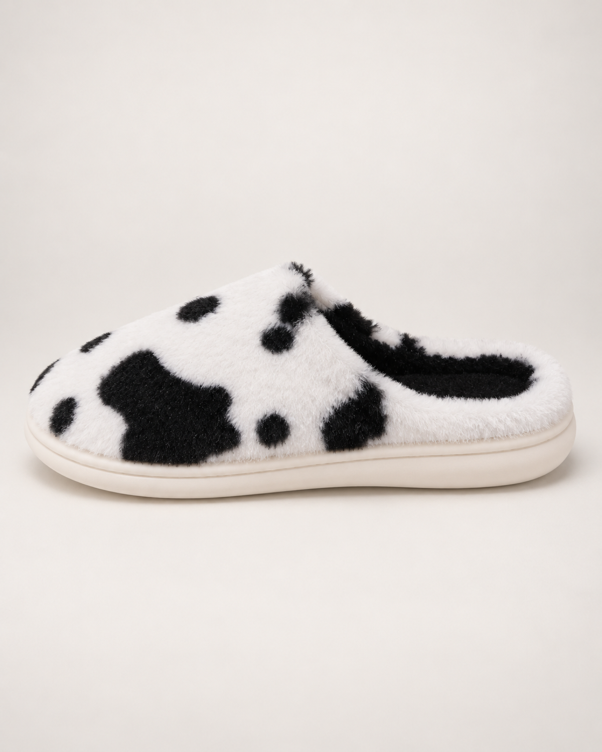 Women's Spotted Cow Slippers in Black, side profile