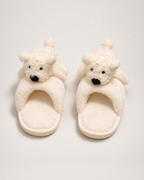 Beige puppy slippers shown from a front and top angle