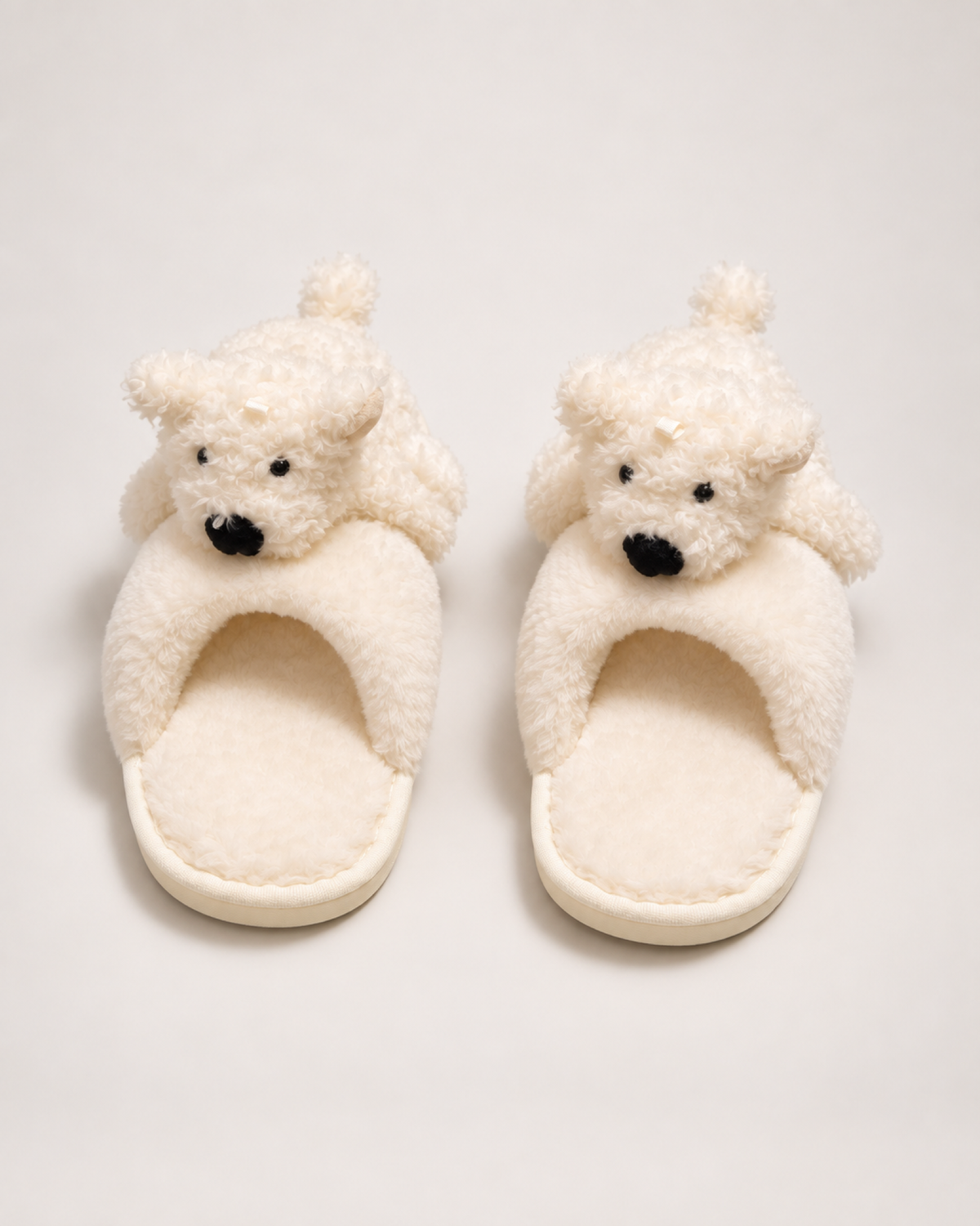 Beige puppy slippers shown from a front and top angle