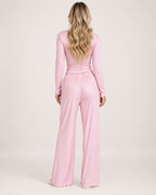 Women's pink V-neck button-front pyjama set, rear studio view