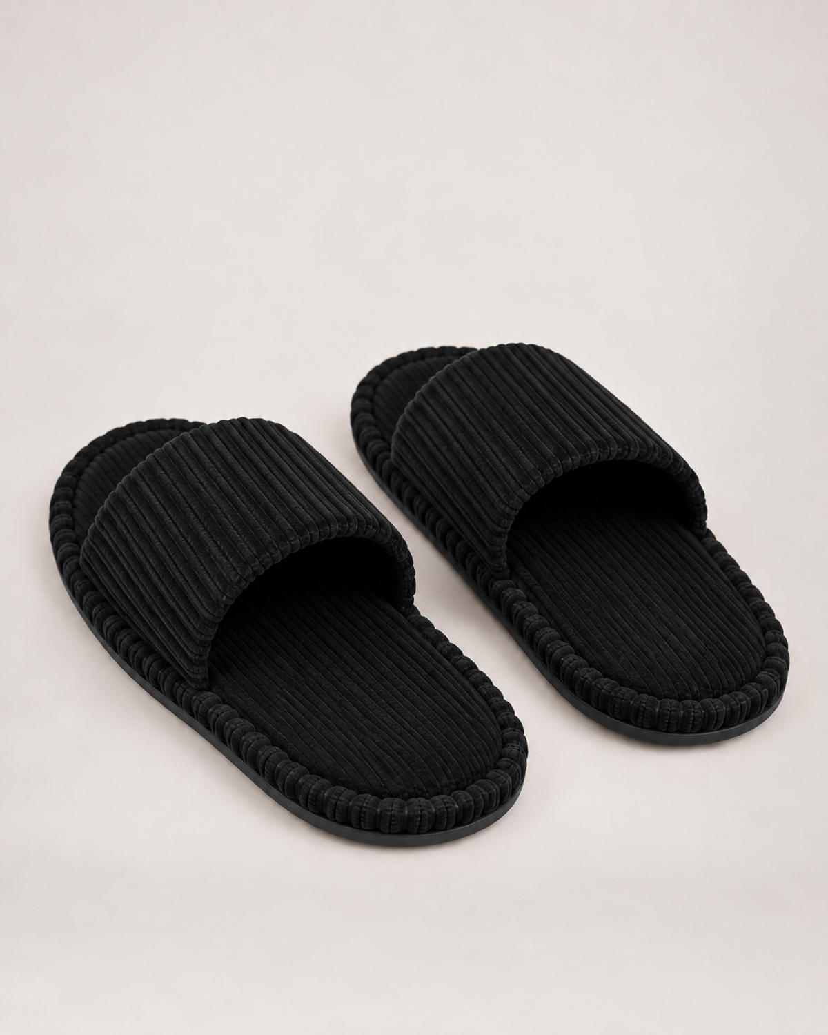 Men's black corduroy open-toe slippers, rear three-quarter studio view