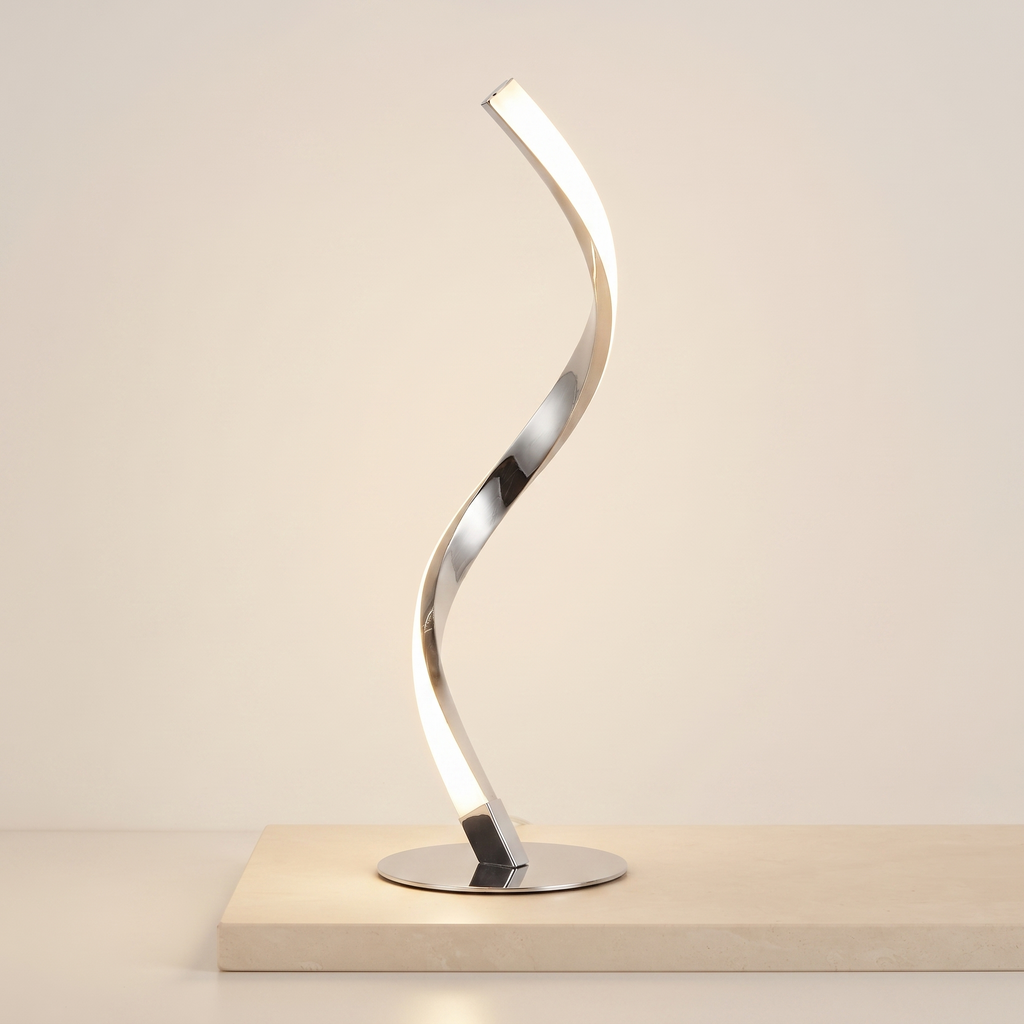 Chrome spiral LED table lamp on a pale stone plinth