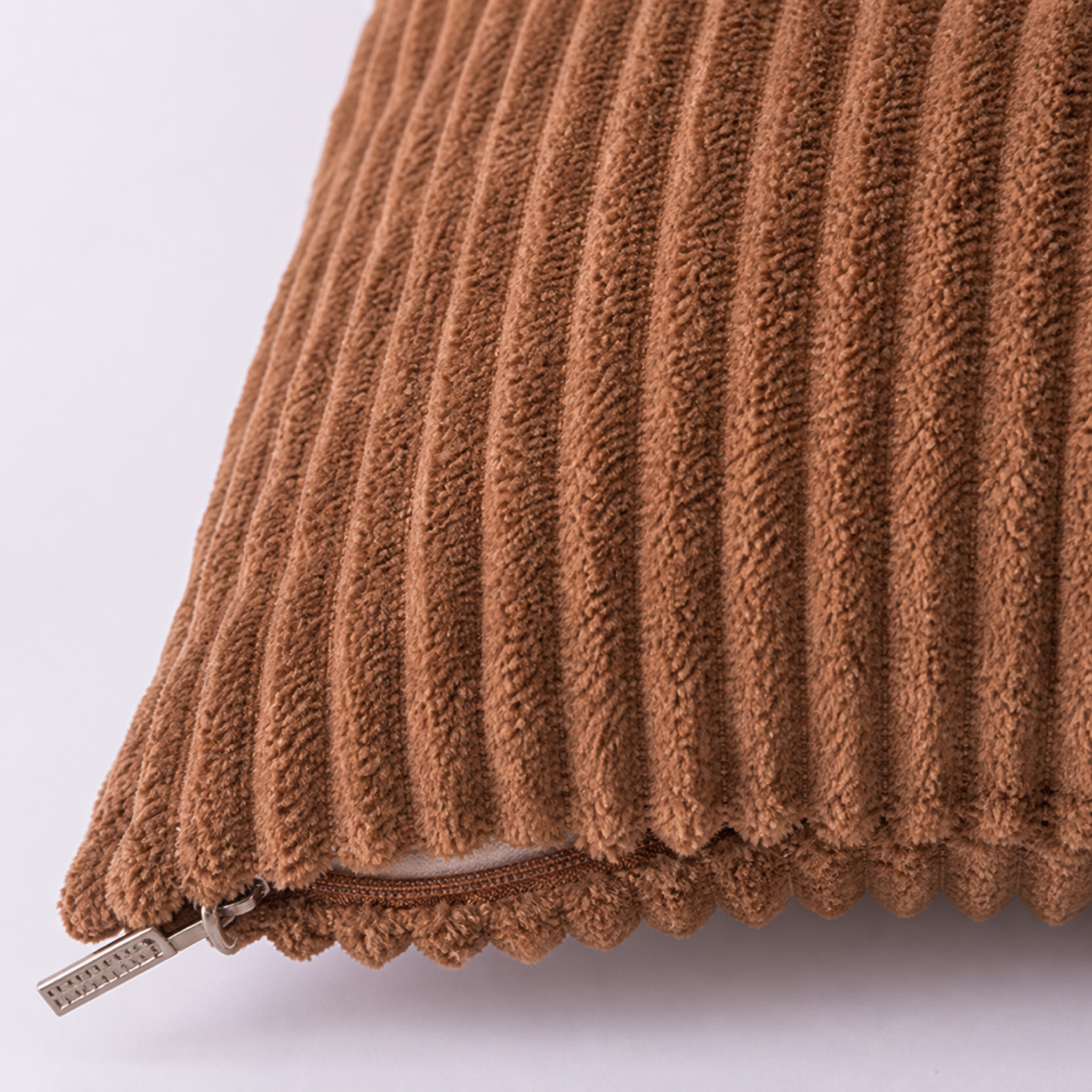 Close-up of the Coffee cushion cover ribbed texture and lower zip