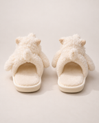 Beige puppy slippers showing their open backs and heel construction