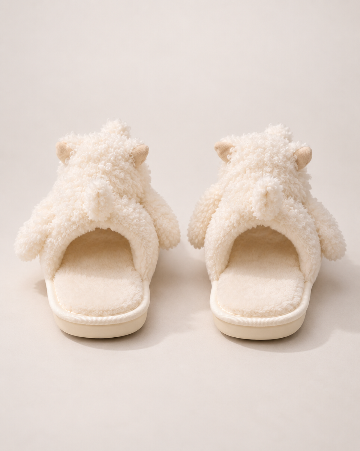 Beige puppy slippers showing their open backs and heel construction