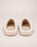White embroidered capybara slippers showing their open backs and heel construction