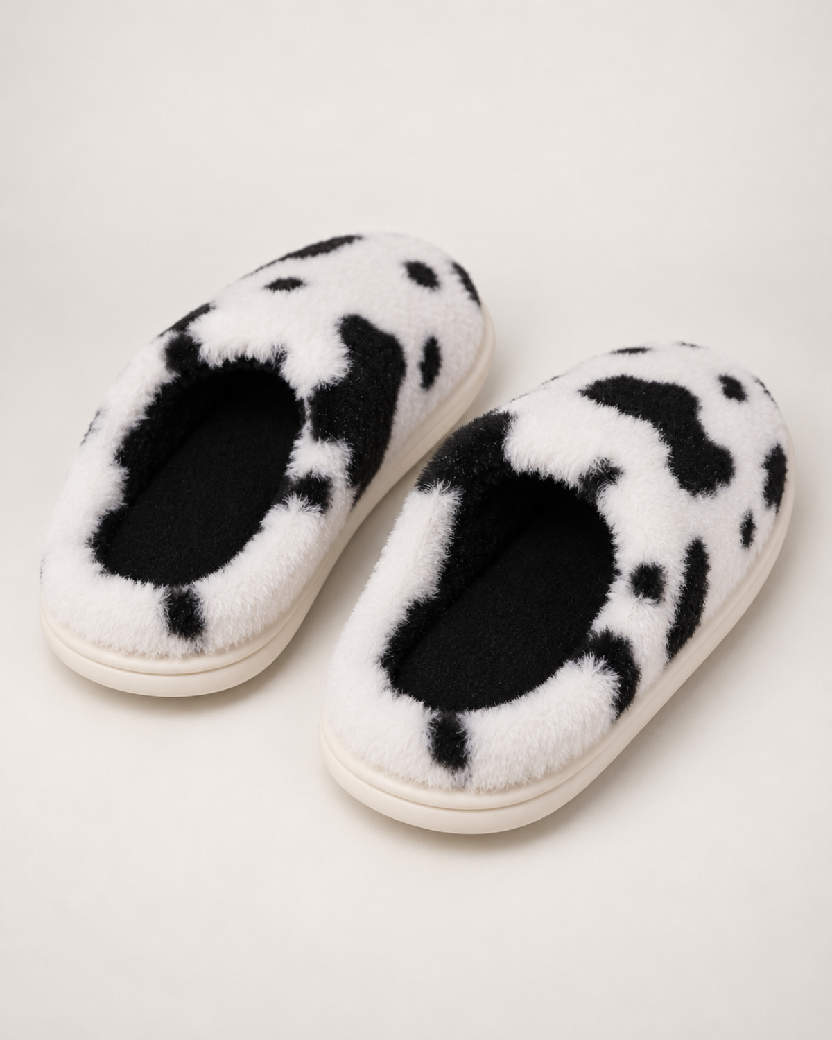 Women's Spotted Cow Slippers in Black, rear heel view