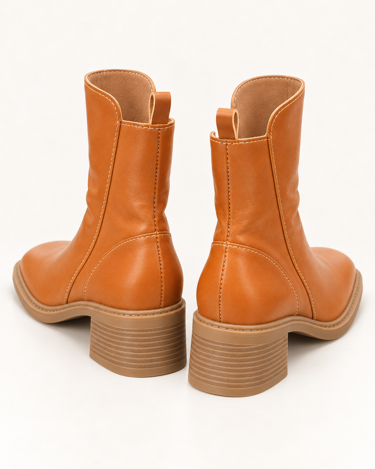 Women's brown chunky block heel ankle boots, rear three-quarter studio view