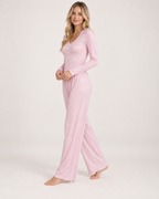 Women's pink V-neck button-front pyjama set, walking studio view