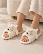 Beige puppy slippers worn indoors by an adult