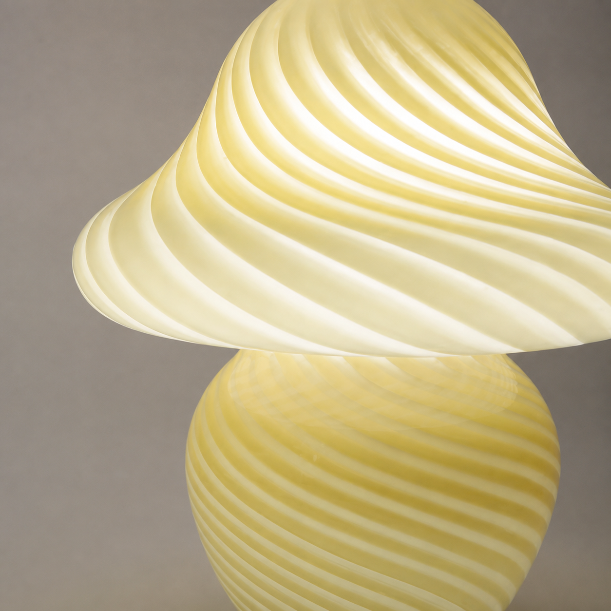 Close detail of the yellow lamp's raised white swirl pattern