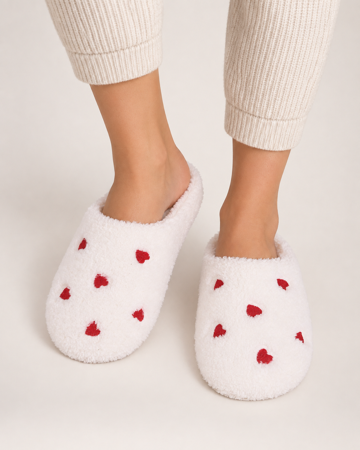 Heart Print Fluffy Slippers in White, worn indoors