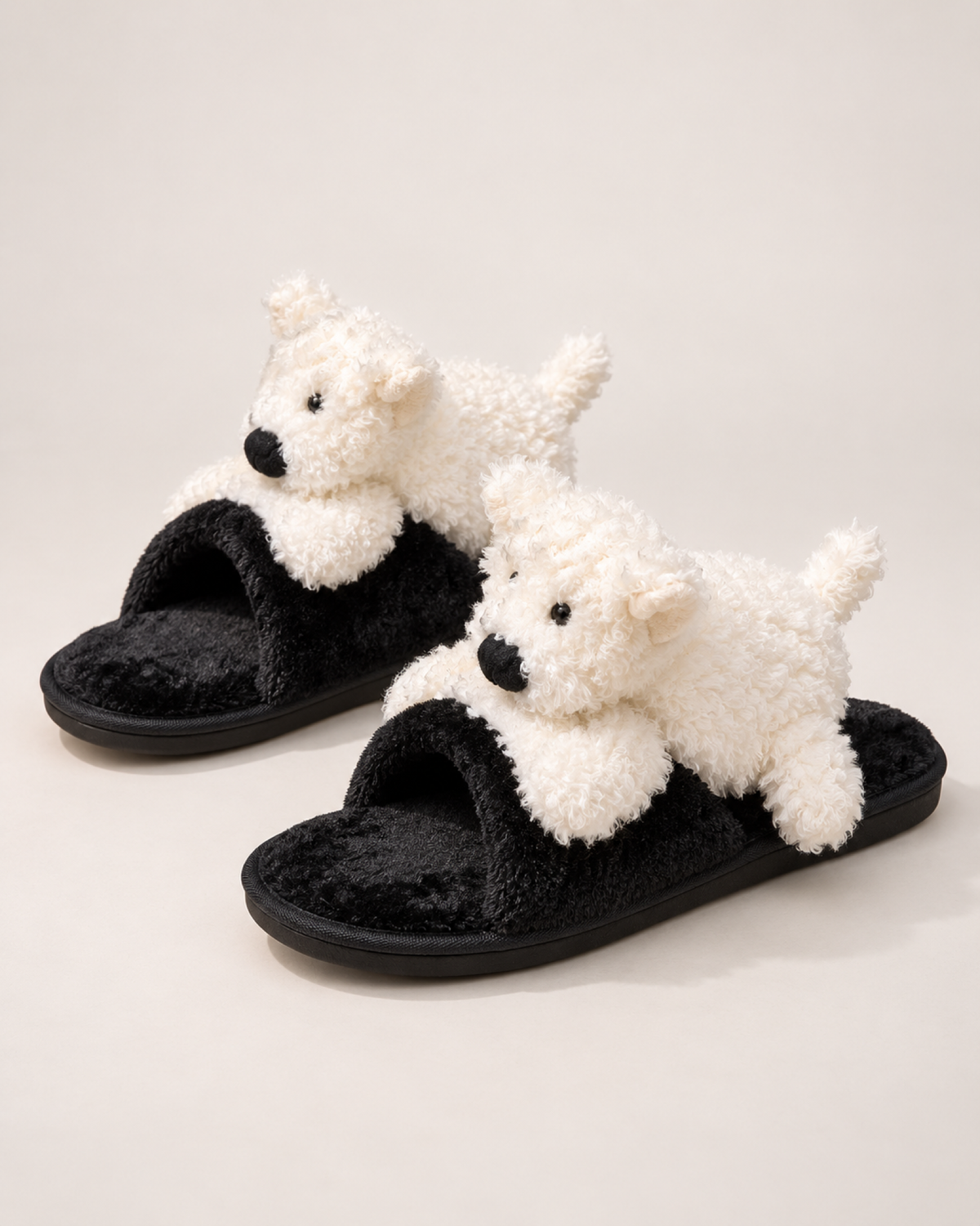 Black puppy slippers with white puppy detail shown as a complete matching pair