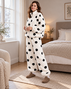 Women's white polka-dot fleece pyjama set, bright bedroom lifestyle view