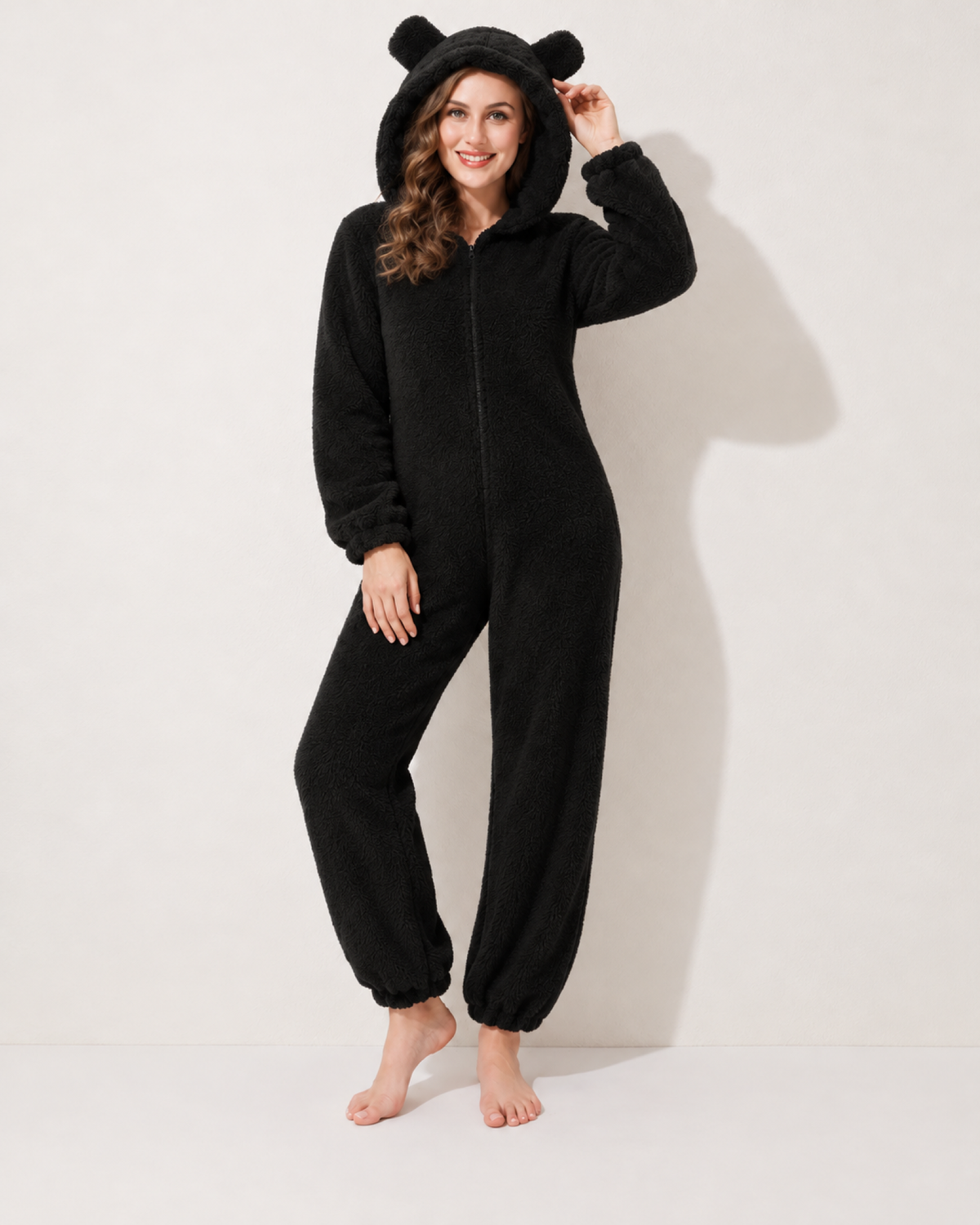 Women's black bear-ear fleece onesie, front studio view