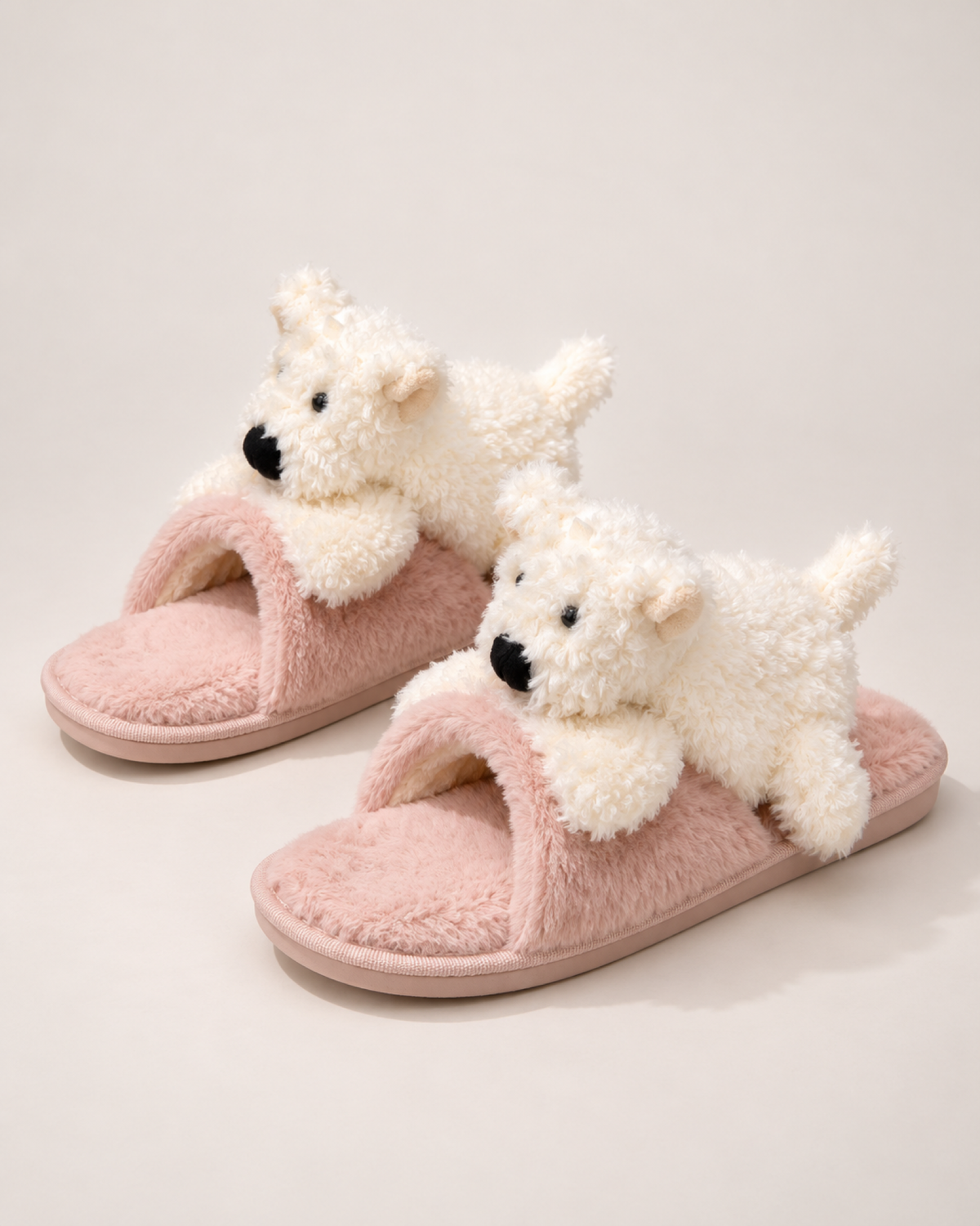 Pink puppy slippers with white puppy detail shown as a complete matching pair
