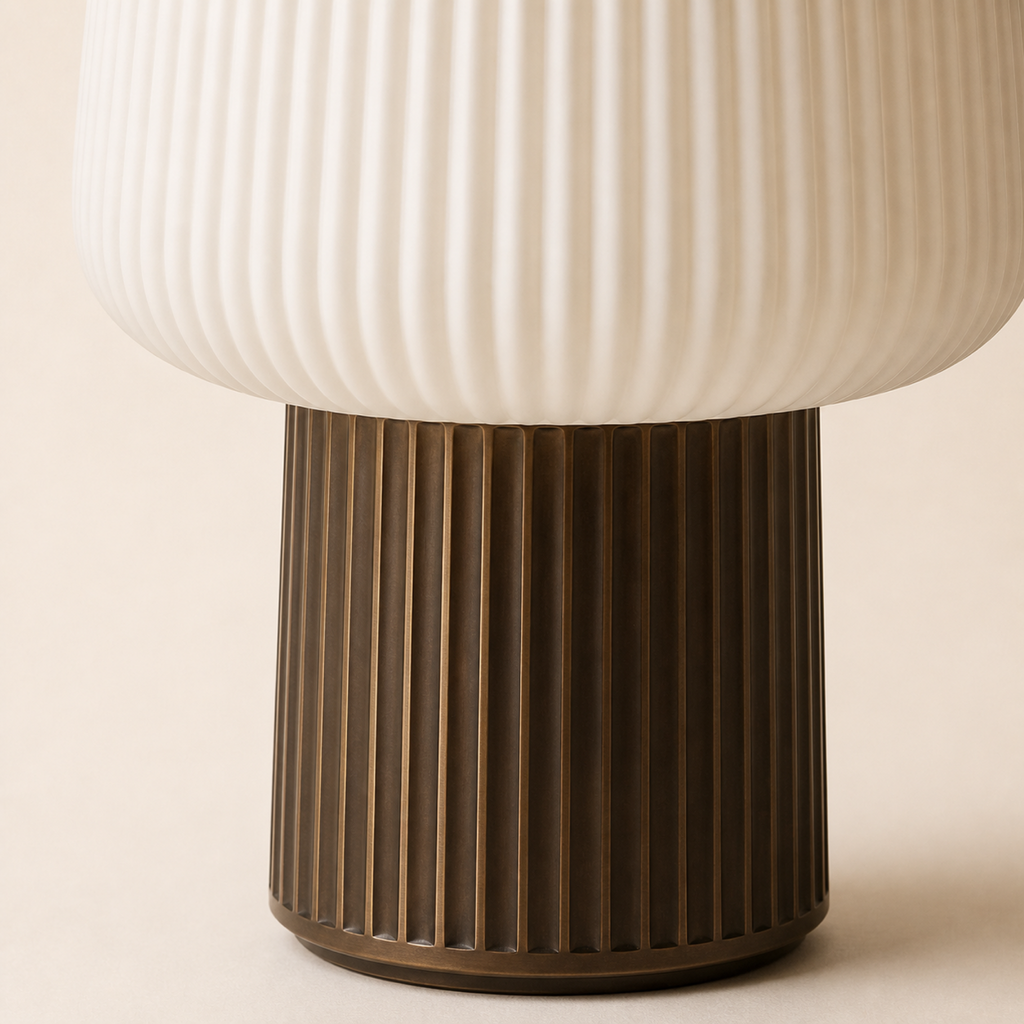 Close detail of the ribbed ivory shade and bronze fluted base