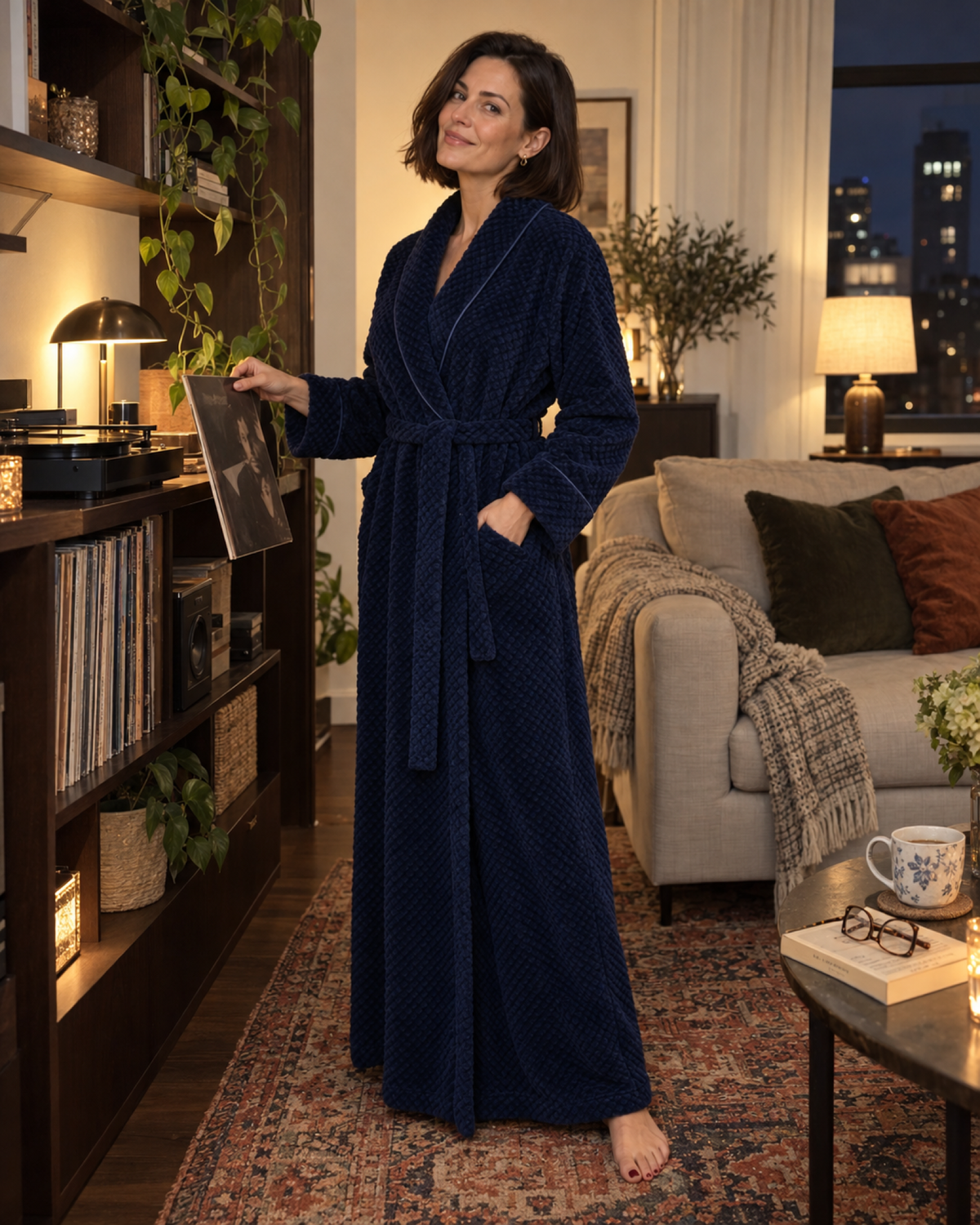 Woman choosing a record in a navy textured long dressing gown