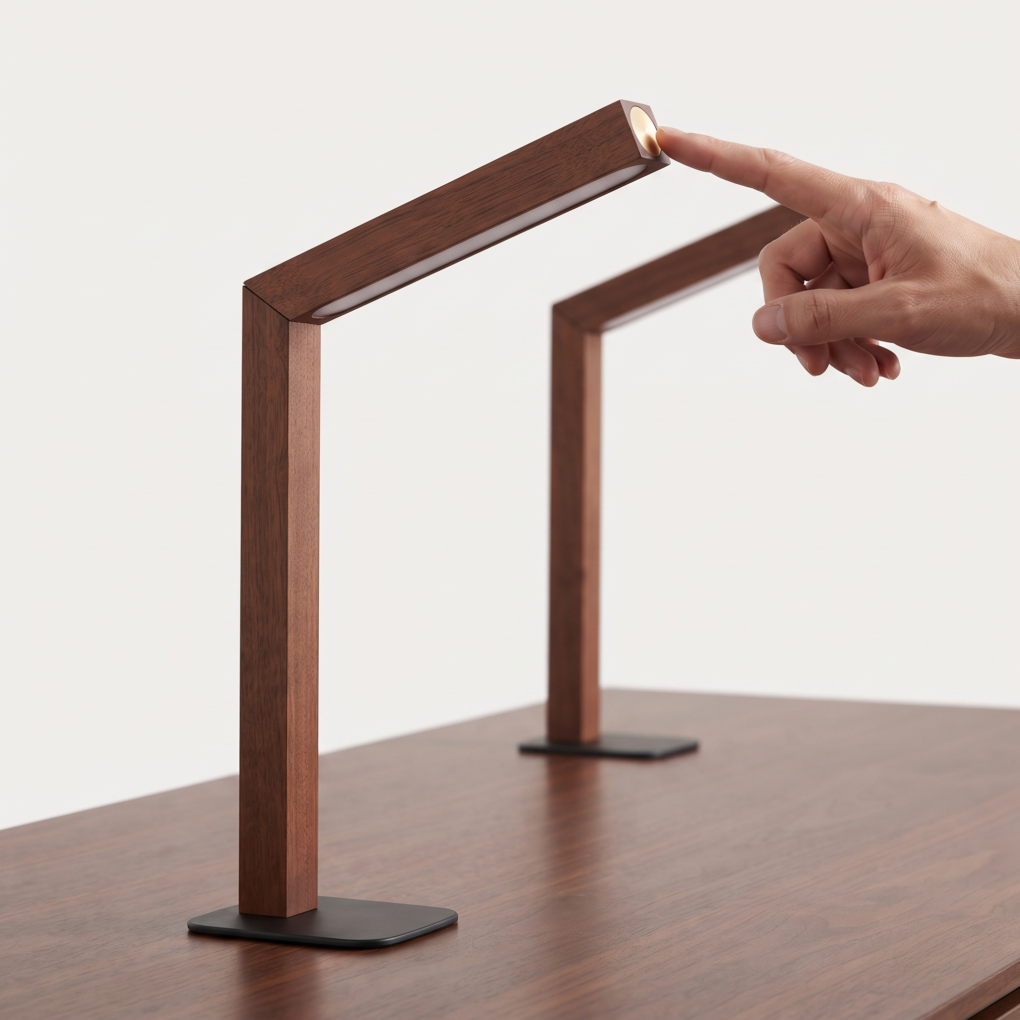 Hand using the round touch control on a walnut finish rechargeable lamp